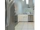 Bright kitchen features stainless steel appliances, white cabinetry and tile flooring at 6516 Remus Dr, New Port Richey, FL 34653