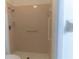 Bathroom features a tile shower with safety bars and a shower head at 6516 Remus Dr, New Port Richey, FL 34653