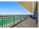 Relax on this balcony with seating and a view of the water and tennis courts below at 7600 Bayshore Dr # 1206, Treasure Island, FL 33706