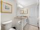 Bathroom features a white vanity with granite counters and accent artwork at 7600 Bayshore Dr # 1206, Treasure Island, FL 33706