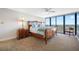Bedroom boasts a balcony access, wood furnishings and a scenic view at 7600 Bayshore Dr # 1206, Treasure Island, FL 33706
