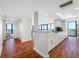 Open condo kitchen featuring white cabinetry, granite countertops, modern appliances, and beautiful wood floors at 7600 Bayshore Dr # 1206, Treasure Island, FL 33706