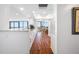 This condominium kitchen features wooden floors, white cabinets, granite counters, and an adjacent dining area at 7600 Bayshore Dr # 1206, Treasure Island, FL 33706