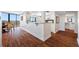 An open condominium kitchen features wood floors, granite counters, white cabinets, and an adjacent dining area at 7600 Bayshore Dr # 1206, Treasure Island, FL 33706