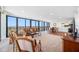 Bright open-concept living room with floor-to-ceiling windows and city skyline views at 7600 Bayshore Dr # 1206, Treasure Island, FL 33706