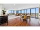 Bright living room with hardwood floors, floor to ceiling windows and a dining area set at 7600 Bayshore Dr # 1206, Treasure Island, FL 33706