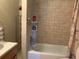 Well-maintained bathroom featuring a shower and tub combination with tile surround at 776 Lakewood Dr, Palm Harbor, FL 34684