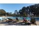 Large community pool with lounge chairs and mature trees surrounding the area at 776 Lakewood Dr, Palm Harbor, FL 34684