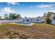 Backyard view with a pool and manicured lawn with mature trees for privacy at 8335 Fountain Ave, Tampa, FL 33615