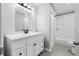 Clean bathroom with a single sink vanity, tiled floors, and a tiled shower at 8335 Fountain Ave, Tampa, FL 33615