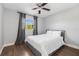 Bedroom with hardwood floors, a ceiling fan, and a view of the sky outside the window at 8335 Fountain Ave, Tampa, FL 33615