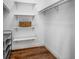 Walk-in closet with hardwood floors, built-in shelves, and ample storage space at 8335 Fountain Ave, Tampa, FL 33615