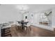 Dining room with modern chandelier, hardwood floors, dining table and chairs with front door view at 8335 Fountain Ave, Tampa, FL 33615