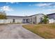 Charming single-story home featuring a gray exterior, attached garage, and well-maintained front yard at 8335 Fountain Ave, Tampa, FL 33615