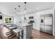 This bright kitchen has a breakfast bar, modern stainless steel appliances, and an open layout to the living room at 8335 Fountain Ave, Tampa, FL 33615