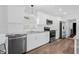 Updated kitchen featuring white cabinetry, stainless steel appliances, granite countertops, and modern fixtures at 8335 Fountain Ave, Tampa, FL 33615