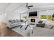 Inviting living room featuring a fireplace, comfortable seating, and view of the backyard at 8335 Fountain Ave, Tampa, FL 33615