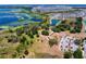 Serene aerial view of community park and lake with lush greenery and winding paths at 8346 Ivy Stark Boulevard, Wesley Chapel, FL 33545
