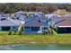 Aerial view of the house, backyard pool, and the surrounding community at 8346 Ivy Stark Boulevard, Wesley Chapel, FL 33545