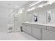 Bright bathroom featuring a glass enclosed shower and double vanity sinks with sleek fixtures and neutral finishes at 8346 Ivy Stark Boulevard, Wesley Chapel, FL 33545