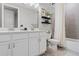 Bright bathroom featuring double sinks, a tiled shower, and a modern vanity at 8346 Ivy Stark Boulevard, Wesley Chapel, FL 33545