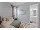Inviting bedroom with a comfy bed, soft textures, and ensuite bathroom view for added convenience at 8346 Ivy Stark Boulevard, Wesley Chapel, FL 33545