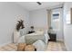 Cozy bedroom features a comfortable bed, neutral decor, and natural light, creating a relaxing retreat at 8346 Ivy Stark Boulevard, Wesley Chapel, FL 33545
