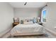 Bright bedroom showcases a comfortable bed, soft lighting, and serene atmosphere for restful relaxation at 8346 Ivy Stark Boulevard, Wesley Chapel, FL 33545