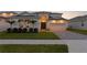 Beautifully landscaped modern home with a paver driveway and a two-car garage at 8346 Ivy Stark Boulevard, Wesley Chapel, FL 33545