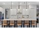 Bright kitchen features a large island, pendant lighting, stainless steel appliances and barstool seating at 8346 Ivy Stark Boulevard, Wesley Chapel, FL 33545