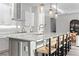 Bright kitchen features a large island, pendant lighting, stainless steel appliances and barstool seating at 8346 Ivy Stark Boulevard, Wesley Chapel, FL 33545