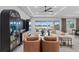 Bright living room with modern decor, hardwood flooring, and a lake view at 8346 Ivy Stark Boulevard, Wesley Chapel, FL 33545