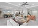 Open floor plan living room with modern decor, a dining area, and a large island kitchen at 8346 Ivy Stark Boulevard, Wesley Chapel, FL 33545