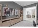 Comfortable home office with a gray walls, ample shelving and adjacent powder room at 8346 Ivy Stark Boulevard, Wesley Chapel, FL 33545
