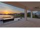 Covered patio with spa overlooking lake at 8346 Ivy Stark Boulevard, Wesley Chapel, FL 33545