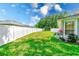 This backyard features a well-maintained lawn and a privacy fence at 8521 Acorn Ridge Ct, Tampa, FL 33625