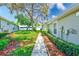 Side yard with mature trees and lush landscaping leading to a cozy home at 8521 Acorn Ridge Ct, Tampa, FL 33625