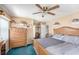 Comfortable bedroom with wooden furniture, soft carpeting, and ample closet space at 8704 Tarrington Pl, Tampa, FL 33635