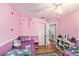 Charming bedroom with hardwood floors, closet, and a whimsical, playful ambiance enhanced by vibrant decor at 8704 Tarrington Pl, Tampa, FL 33635