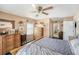 Bedroom with wooden furniture, fan, and natural light at 8704 Tarrington Pl, Tampa, FL 33635