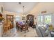 Cozy dining area featuring a dining table set for six, display cabinet, and tile flooring, perfect for Gathering meals at 8704 Tarrington Pl, Tampa, FL 33635