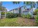 Charming two-story home featuring a well-maintained lawn with mature landscaping and an American flag at 8704 Tarrington Pl, Tampa, FL 33635