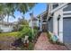 Inviting home exterior, showcasing a brick walkway, flagpole, and colorful landscaping, offering curb appeal at 8704 Tarrington Pl, Tampa, FL 33635