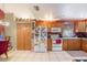 Open kitchen with wooden cabinets, white appliances, and ample storage space at 8704 Tarrington Pl, Tampa, FL 33635