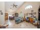 Open-concept living space with vaulted ceilings, neutral tones, tile floors, and a cozy seating arrangement at 8704 Tarrington Pl, Tampa, FL 33635