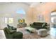 Bright living room featuring high ceilings, ample natural light, and stylish contemporary furniture at 8704 Tarrington Pl, Tampa, FL 33635