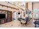 Inviting living area with vaulted ceilings, decorative shelving, and comfortable furnishings, creating a welcoming atmosphere at 8704 Tarrington Pl, Tampa, FL 33635