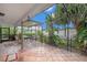 Inviting outdoor patio with lush greenery and tile flooring at 8704 Tarrington Pl, Tampa, FL 33635