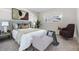 Well-lit bedroom featuring a comfortable bed and accent chair at 9 Forbes Pl # 205, Dunedin, FL 34698