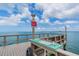 Community dock with cleaning station and beautiful water views on a sunny day at 9 Forbes Pl # 205, Dunedin, FL 34698